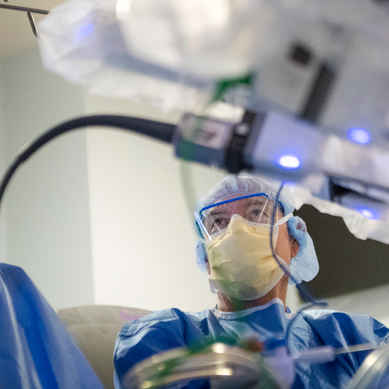 A Novant Health surgeon is performing surgery with robotics technology in an operating room. 