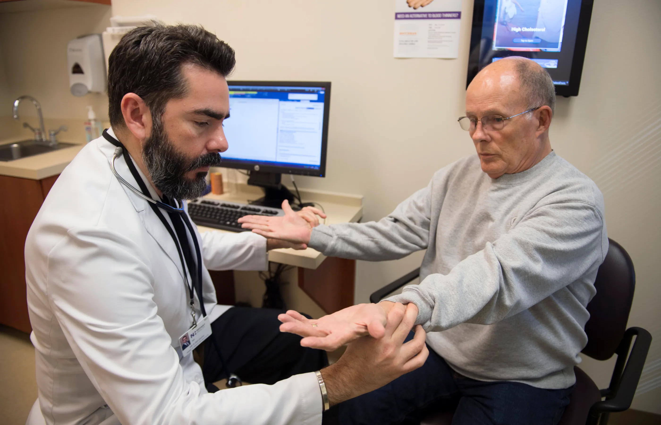 Novant Health's Dr. Delgado is examining a patient hands.